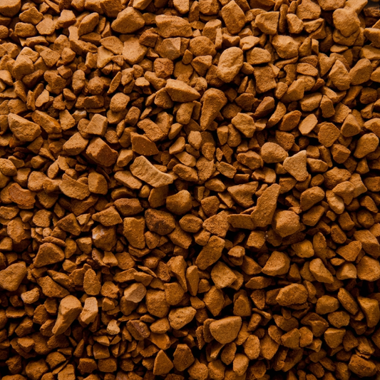 Close-up of freeze-dried instant coffee granules showing rich texture and quality